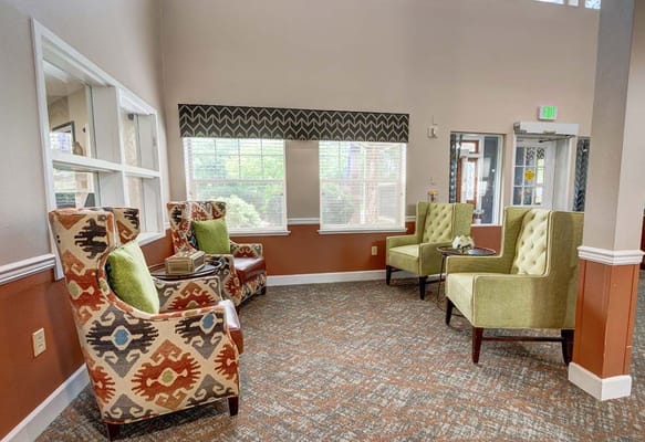 Lounge area with colorful chairs and natural light