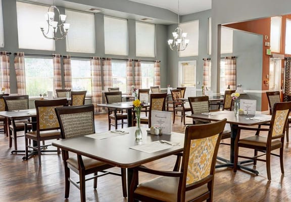 Spacious dining area with tables and chairs in The Chateau at Gardnerville