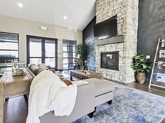 Cozy common area with stone fireplace and seating