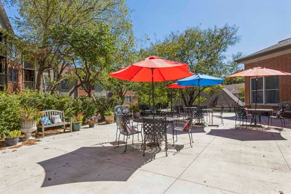Outdoor patio with umbrellas and seating area