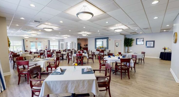 Dining room with neatly set tables and chairs