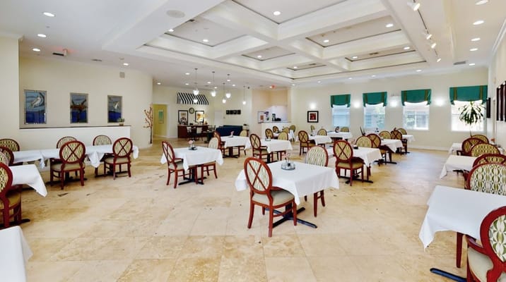 Spacious dining area with tables and chairs in The Goldton at St. Petersburg.