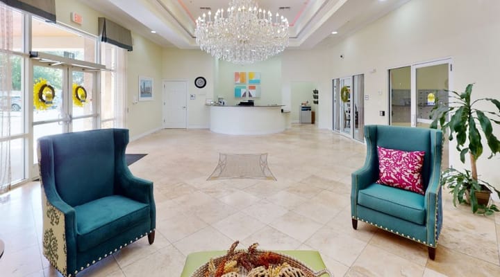 Lobby area featuring comfortable chairs and a chandelier