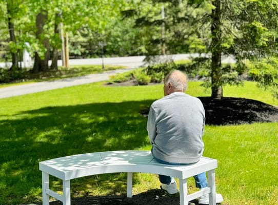 Resident enjoying a peaceful moment in the garden