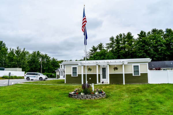 Exterior view of the facility with grounds and flags