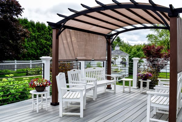 Outdoor seating area with white chairs and flowers