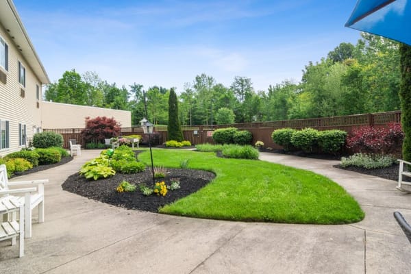 Well-maintained patio garden with flowers and greenery at The Landing of Stow.