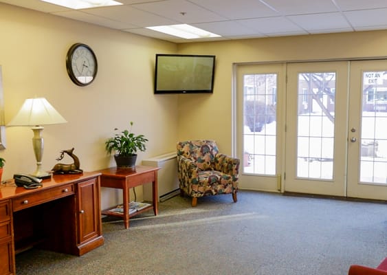 Cozy lounge area with a chair and TV