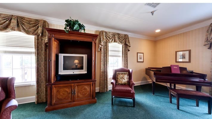 Interior view of a common area with seating and a piano
