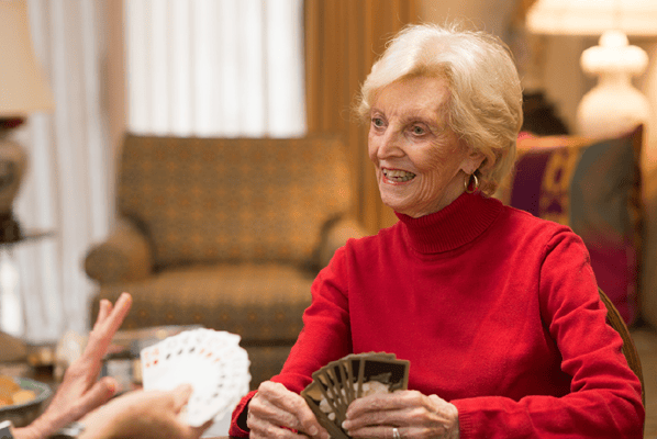 A resident enjoying a card game in a common area