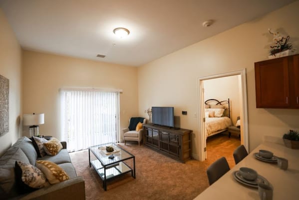 Bright living room with a sofa, coffee table, and TV.