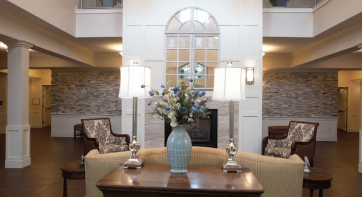 Cozy lobby with seating, lamps, and decorative flowers