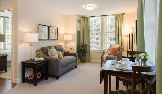 A cozy living room with comfortable seating and a dining table.