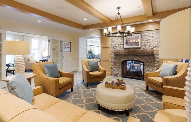 Cozy living room with orange armchairs and a stone fireplace