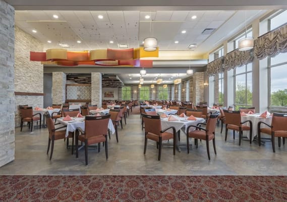 Spacious dining room with arranged tables and chairs.