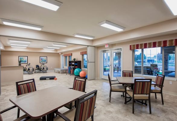 Spacious common area with seating and exercise equipment