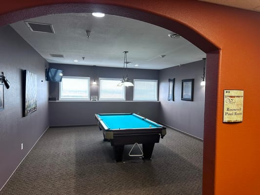 Interior view of a pool room with a blue table