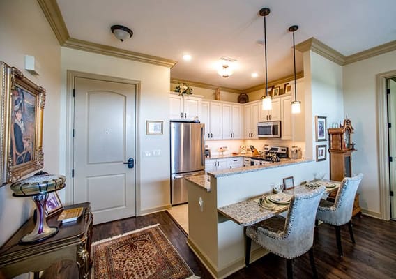 Bright interior kitchen area with seating and decor