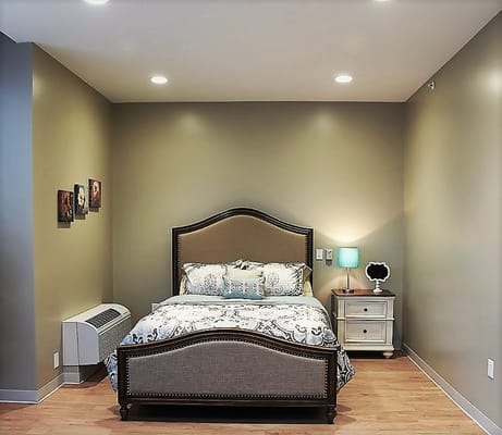 A cozy resident bedroom with a bed and lamp