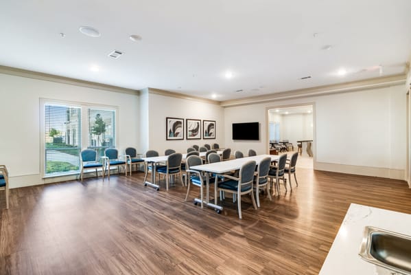 Bright activity room with tables and chairs