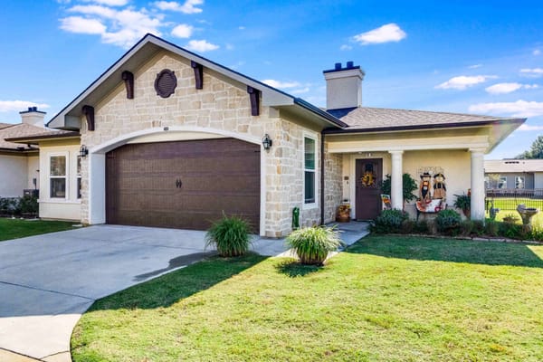Exterior of a single-family home with a stone facade and garage