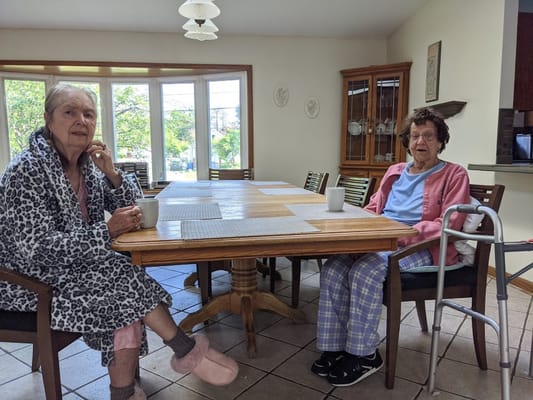 Two residents enjoying coffee in a cozy dining area