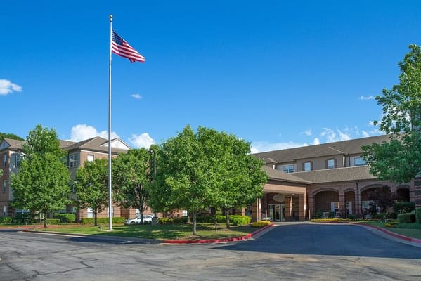 Exterior view of Town Village Tulsa with American flag