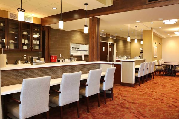 Bright dining area with a counter and seating at Traditions at North Bend