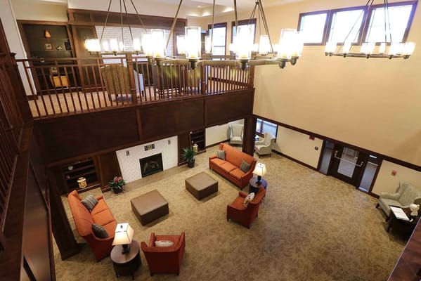 Spacious lounge area with seating arrangements and a fireplace