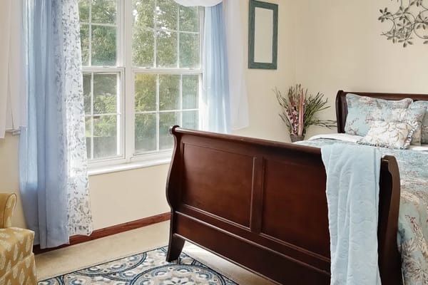 Cozy bedroom with a wooden bed and blue curtains