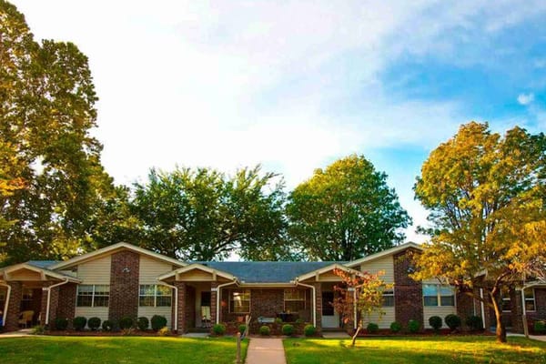 Exterior view of residential buildings at University Village Retirement Community with trees