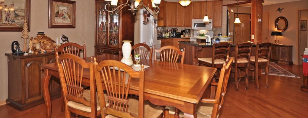 Spacious dining area with wooden table and chairs