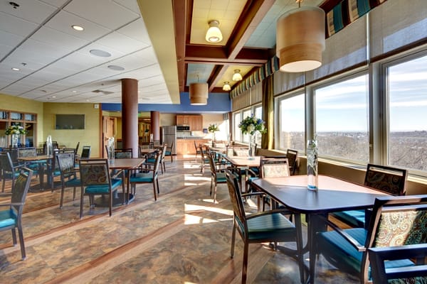 Bright dining area with tables and large windows