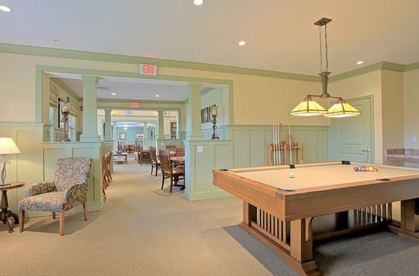 Spacious game room with a pool table and seating area
