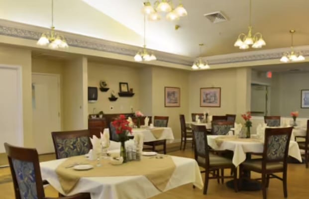 Dining area set for a meal with floral centerpieces