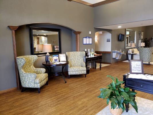 Two patterned chairs and a round table in the lobby