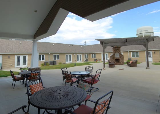 Outdoor courtyard with seating and a fireplace