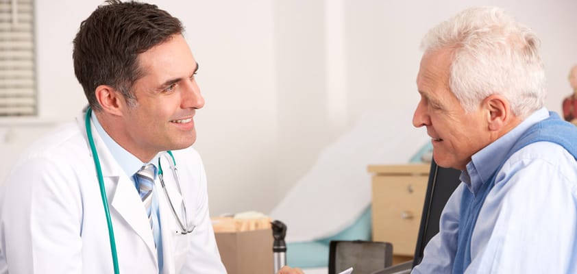 A healthcare professional interacting with an older man
