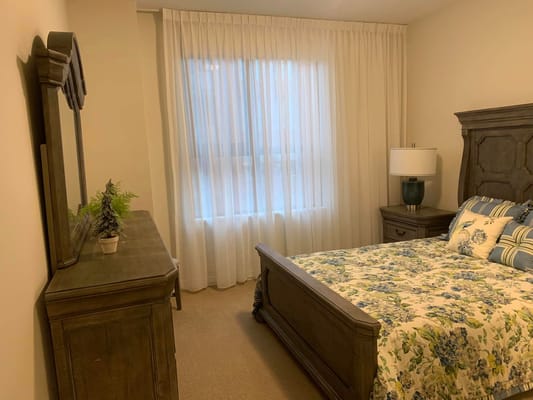 Cozy resident room with a bed and soft curtains