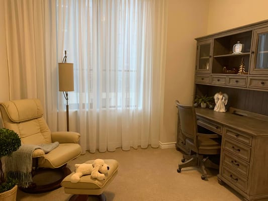 Cozy resident room with a chair and desk