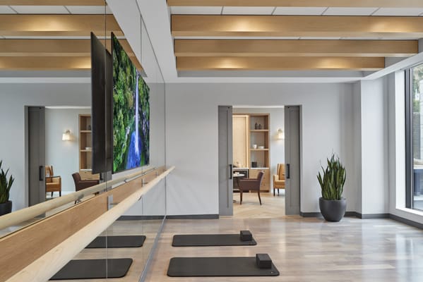 Interior view of a wellness studio with exercise mats