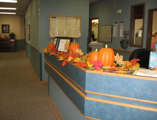 Decorated reception area with pumpkins and fall leaves