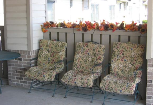 Outdoor seating area with floral-patterned chairs
