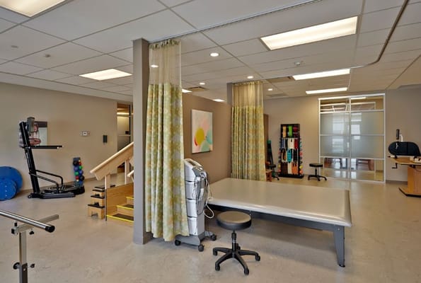 Interior of a therapy room with equipment and treatment table