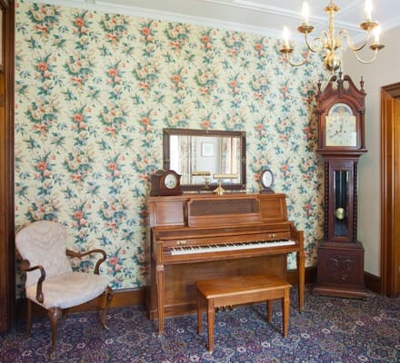 Cozy interior with a piano and antique clock