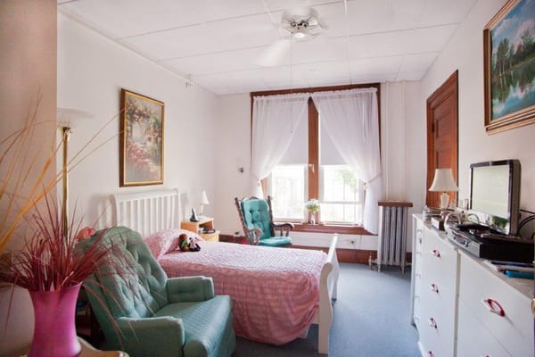 Cozy private resident room with a bed and seating area