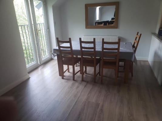Wooden dining table with chairs and sliding doors