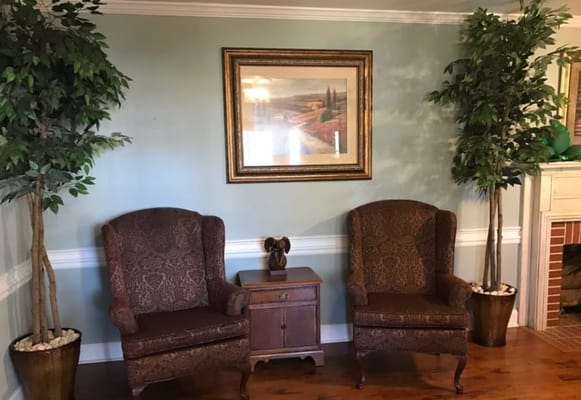 Cozy seating area with armchairs and artwork