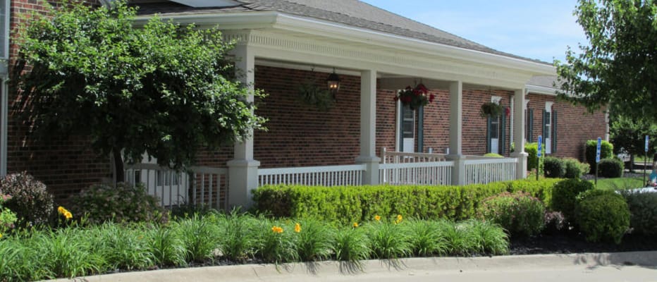 Exterior view of Windmill Manor with well-maintained landscaping
