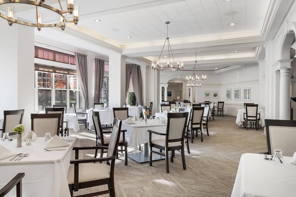 Elegant dining room with tables set for a meal